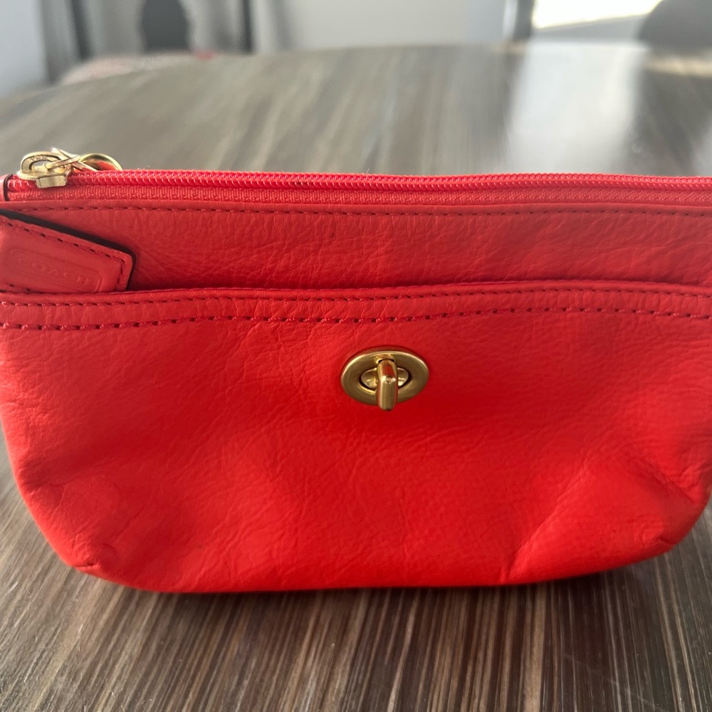 Coach Orange Wristlet with Gold Accents and Textured Finish